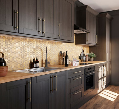 Dark grey galley kitchen with gold effect mosaic tiled splashback.