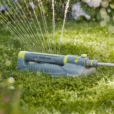 A Verve sprinkler spraying water in a fan shape across a lawn.