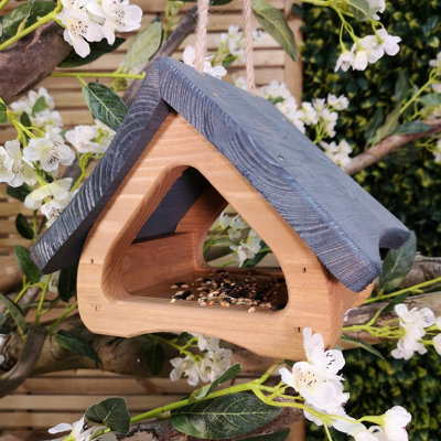 https://media.diy.com/is/image/KingfisherDigital/faraway-modern-wooden-garden-wild-bird-hanging-easy-fill-seed-feeder-table-with-grey-roof~5056589110048_01c_MP?$MOB_PREV$&$width=768&$height=768