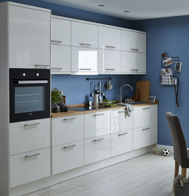 Blue and white galley kitchen with white gloss cabinets.