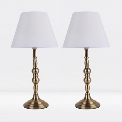 First Choice Lighting Set of 2 Antique Brass Plated Bedside Table Light with Candle Column White Fabric Shade