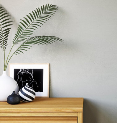 A room with walls painted in grey glitter effect paint, adding subtle shimmering highlights for a dreamy, multi-dimensional look.