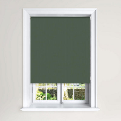Green blackout roller blinds installed on a small window.