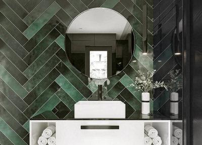 Modern bathroom with large green tiles place in a herringbone pattern up the wall