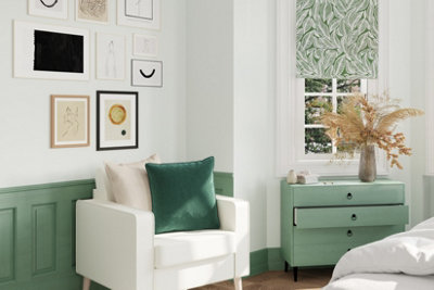 White and green bedroom with green wainscoting on lower half of wall, and the rest of the walls painted in white.