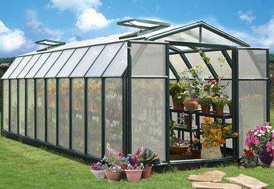 A large rectangular glass and metal greenhouse with an apex roof.