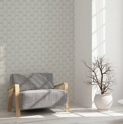A grey and white living room with grey patterned wallpaper and a statement grey chair.