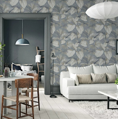 Grey living room decorated with leaf print grey wallpaper, white sofa, and light wooden flooring.