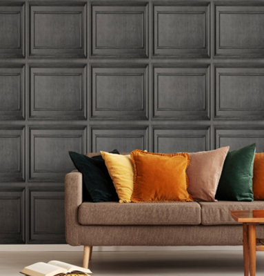 Grey living room with dark grey panel effect wallpaper and a beige sofa decorated with yellow, green, and orange cushions.