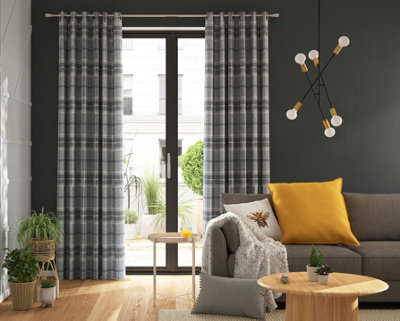 A grey living room with a grey sofa and yellow cushions.