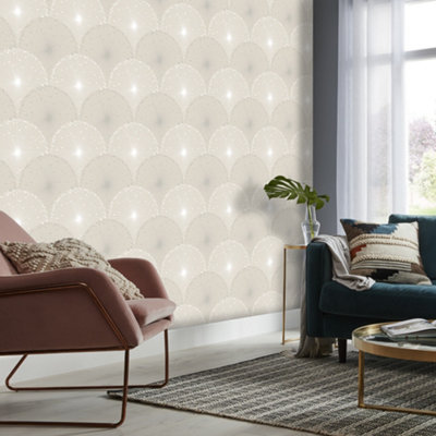 Grey living room with light grey metallic effect wallpaper, striped rug, a pink armchair and a dark green sofa.