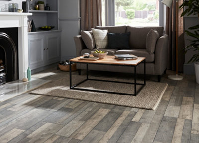 A grey living room with rustic wood effect laminate flooring.