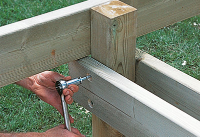 Securing two support beams to a decking post underneath the sub-frame joists.