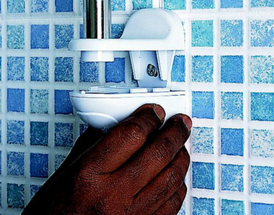 Pushing the bracket cover for a bathroom shower rail upwards onto the shower rail bracket.