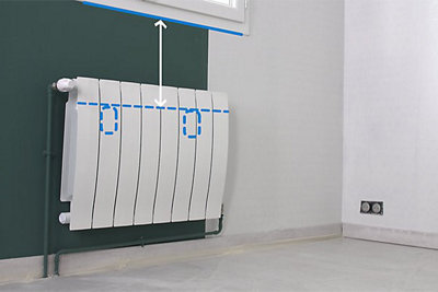 Illustration showing that wallpaper should be installed behind a radiator, then cut to line up with the top of the radiator fixings.