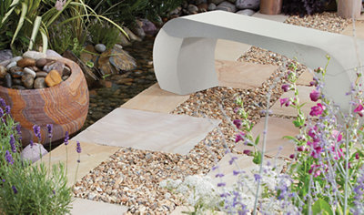 A garden path with a combination of paving slabs and gravel which will allow water to drain.