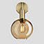 Industville Sleek Tinted Glass Globe Wall Light, 7 Inch, Amber, Brass Holder