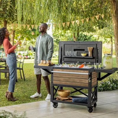 Keter 85L Patio Cooler & Beverage Cart Ice Chest with Wood Look Resin, Side Shelves, Drain, Bottle Opener, Wheels & Locking Lid