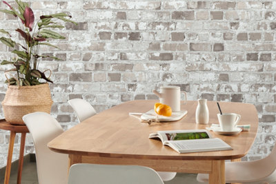 Grey and white rustic brick effect wallpaper in a dining room.