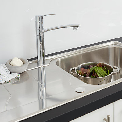 A chrome single-lever kitchen tap with one lever for controlling temperature and water flow at the top of the tap, and a long horizontal spout.