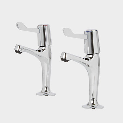 Two chrome kitchen pillar taps, each with a lever on top for controlling water flow and a horizontal spout.