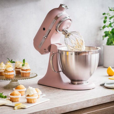 https://media.diy.com/is/image/KingfisherDigital/kitchenaid-artisan-mixer-185-feather-pink~8003437045387_04c_MP?$MOB_PREV$&$width=618&$height=618