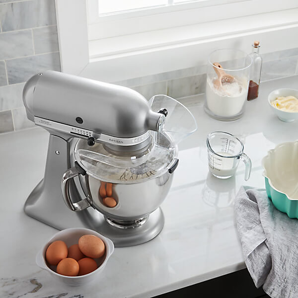 https://media.diy.com/is/image/KingfisherDigital/kitchenaid-pouring-shield-secure-fit-for-4-8l-mixer-bowls~8003437048326_04c_MP?$MOB_PREV$&$width=618&$height=618
