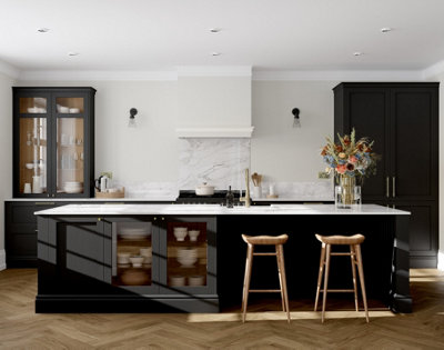 Large black and white kitchen with black cabinetry, white walls, and a large kitchen island.