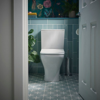 Small, light blue cloakroom bathroom with geometric tiles on the floor.