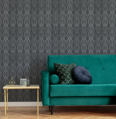Living room with dark grey and metallic geometric wallpaper, teal green sofa, and light wooden flooring.