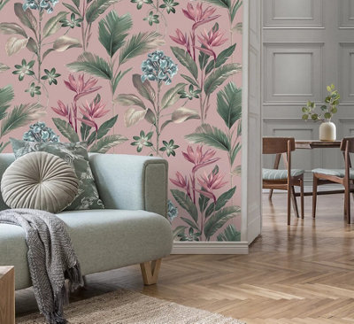 Living room with pink floral wallpaper, grey sofa with grey blanket and cushions, and light wooden flooring.