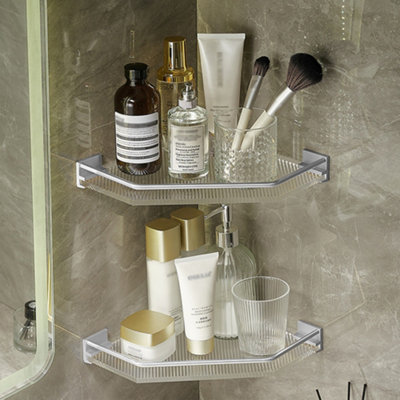 https://media.diy.com/is/image/KingfisherDigital/livingandhome-silver-wall-mounted-acrylic-bathroom-corner-shelf-shower-storage-organiser~0735940247344_02c_MP?$MOB_PREV$&$width=618&$height=618