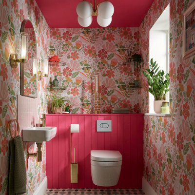 Small pink cloakroom with floral wallpaper and tongue and groove panelling.