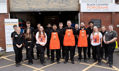 Merry Hill B&Q employees standing outside Black Country Food Bank warehouse