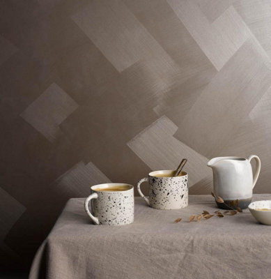 A room with a wall coated in Craig & Rose Tempered Bronze Metallic effect paint, creating a glimmering look with a subtle touch of glam.