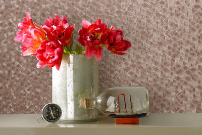 Metallic effect kitchen wallpaper in a room with a vase full of pink flowers.