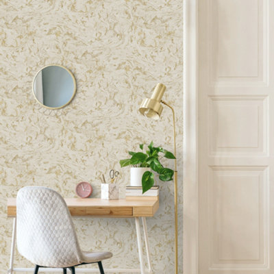 Metallic marble effect wallpaper in a home office with a small wooden desk and light grey desk chair.