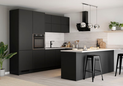 A large modern kitchen with black cabinetry, white worktops and a large island with 2 black bar stools.