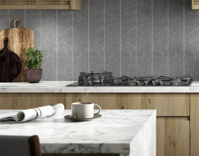 Modern kitchen with black and white herringbone style splashback tiles.