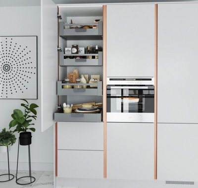 Modern white kitchen with handleless cabinets and integrated appliances and storage.
