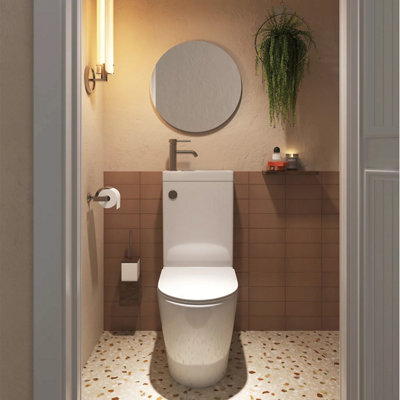 Small cloakroom with neutral paint, tan wall tiles and terrazzo vinyl on the floor.