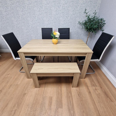 OAK EFFECT TABLE AND BENCH WITH 4 BLACK WHITE STRIPPED FAUX LEATHER CHAIRS