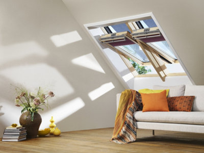 Two roof windows installed on a sloping roof are open to allow air into the room.