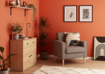 An orange living room with wooden furniture and black accents.
