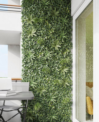Living wall with a vibrant mix of ferns, succulents, and flowers, transforming an external wall into a lush vertical garden.