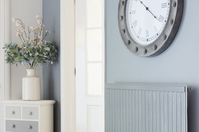 A light grey wall styled with a matching grey radiator. Read the GoodHome renovation paint buying guide. 