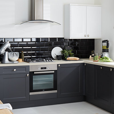 Modern kitchen with dark grey-blue cabinets with black metro tile splashback and bright white walls. Shop GoodHome kitchen and bathroom paint. 