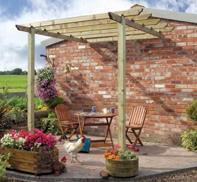 A pergola attached to a summer house, creating a tranquil outdoor space with vibrant bedding plants in containers and hanging baskets.