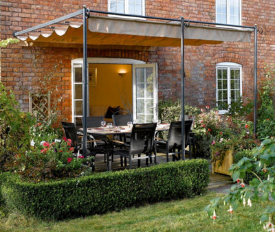 A pergola with a retractable canopy, providing flexible shelter for outdoor dining.