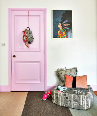 A room with doors, door frames, and skirting boards painted in pink, creating stylish look with a modern twist.